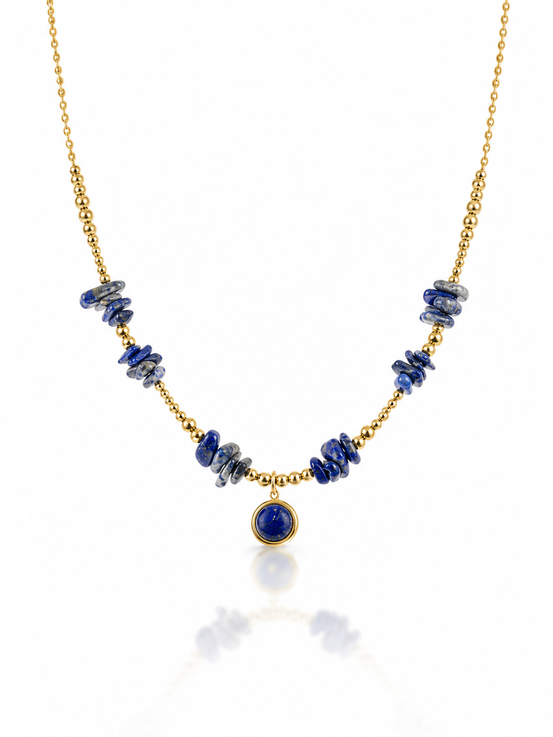 A gold chain necklace featuring irregular dark blue lapis lazuli stone chips on either side of a central round blue stone pendant, displayed on a clean white background with a soft reflection.